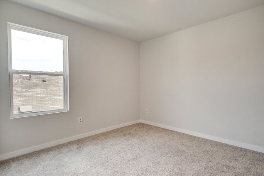 A room with a window and a carpet. A room with a window and a carpet.