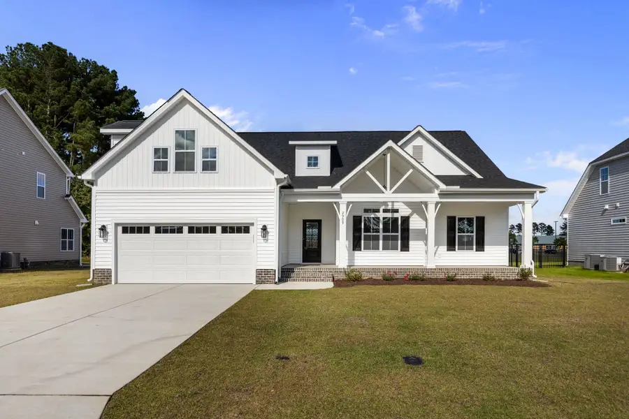 Front exterior of a new home in The Preserve at Langston, Winterville, NC, highlighting curb appeal (Image 1).