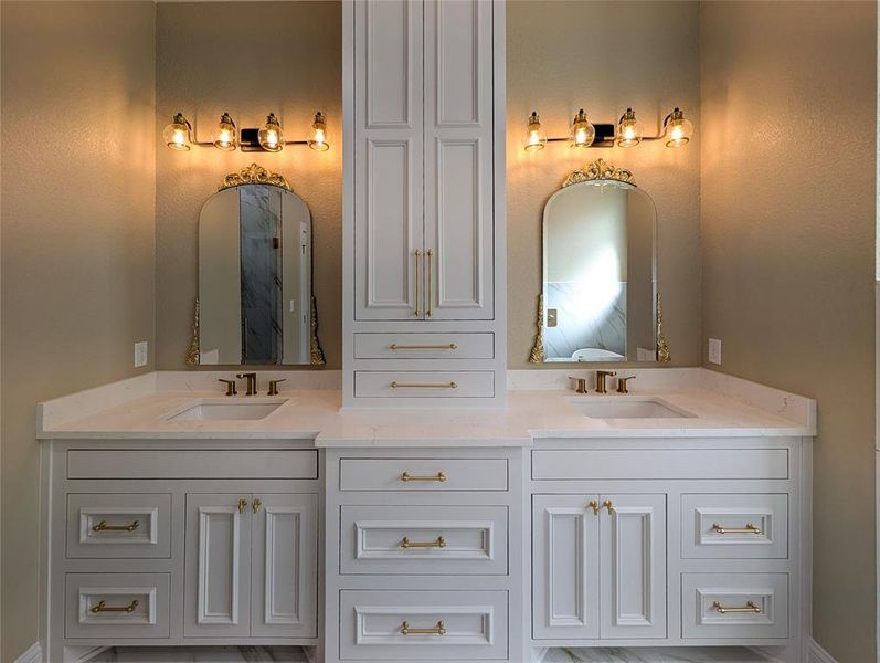 Full bathroom with double vanity and baseboards