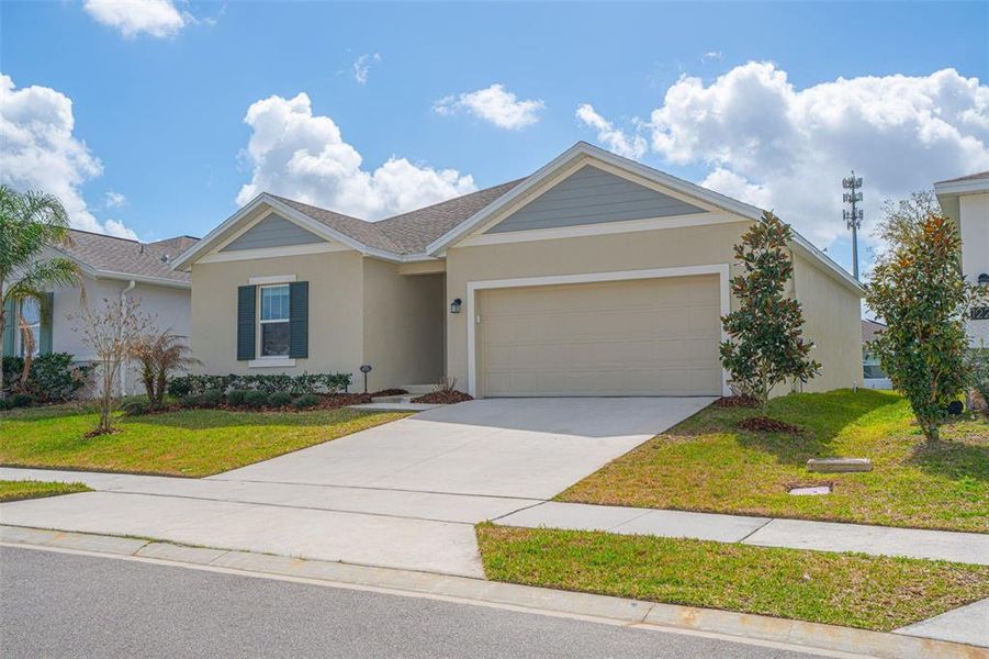 Front exterior of a new home in Vineland Reserve, Osteen, FL, highlighting curb appeal (Image 22).