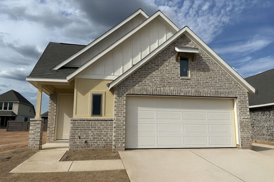 Front exterior of a new home in Escondido, Magnolia, TX, highlighting curb appeal (Image 1). Front exterior of a new home in Escondido, Magnolia, TX, highlighting curb appeal (Image 1).