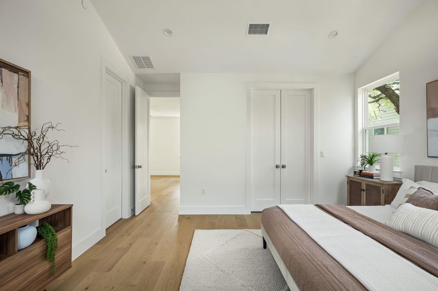 Hardwood floors and bright windows create an inviting bedroom sanctuary. Hardwood floors and bright windows create an inviting bedroom sanctuary.