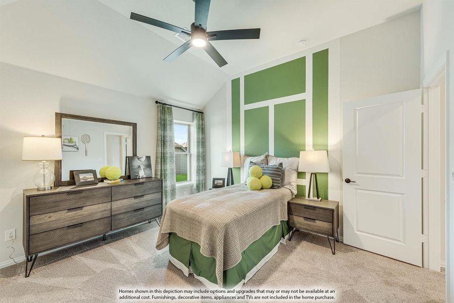 Bedroom with vaulted ceiling, green accent wall, ceiling fan, and wood dresser with mirror