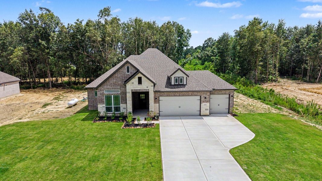Front exterior of a new home in Encino Estates, Dayton, TX, highlighting curb appeal (Image 21).