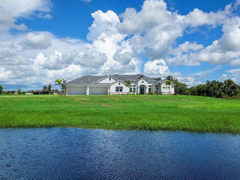 Front exterior of a new home in Hampton Lakes, Sarasota, FL, highlighting curb appeal (Image 24).
