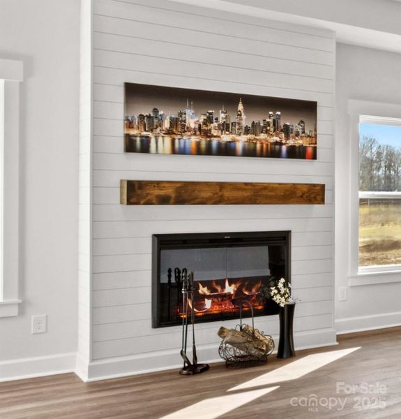 Family Room with electric fireplace on shiplap wall.