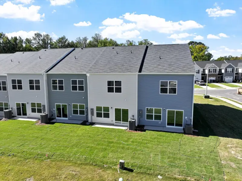 Exterior details and patio area of a home in West Main Townhomes, Sanford (Image 3).