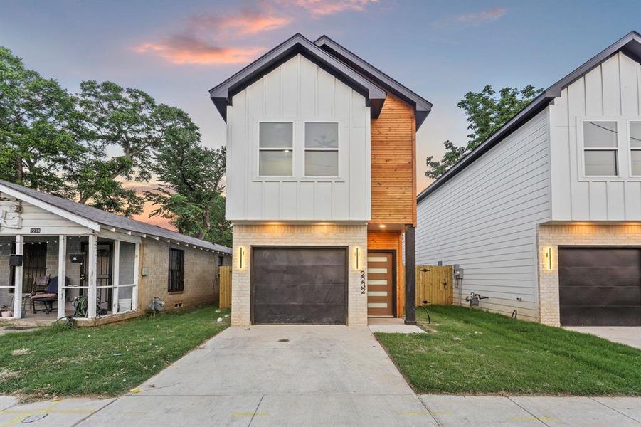 Contemporary house featuring board and batten siding, concrete driveway, and a garage Contemporary house featuring board and batten siding, concrete driveway, and a garage