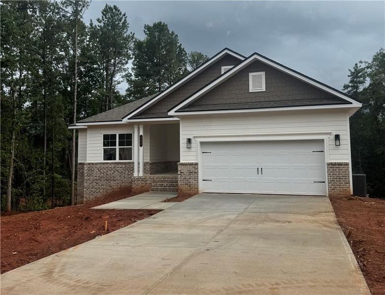 Front exterior of a new home in The Fields of Walnut Creek, Pendergrass, GA, highlighting curb appeal (Image 1). Front exterior of a new home in The Fields of Walnut Creek, Pendergrass, GA, highlighting curb appeal (Image 1).