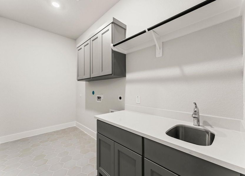 Utility Room with Washer and Dryer Connections, Sink, Hang to Dry Bar, Storage Cabinets, and Folding Area. Utility Room with Washer and Dryer Connections, Sink, Hang to Dry Bar, Storage Cabinets, and Folding Area.