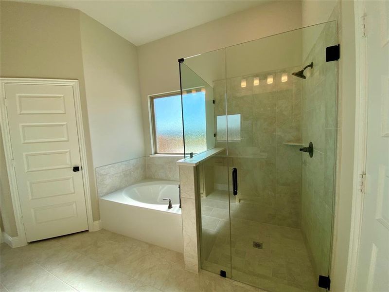 Separate garden tub and dropped tile shower with frameless glass & ORB fixtures