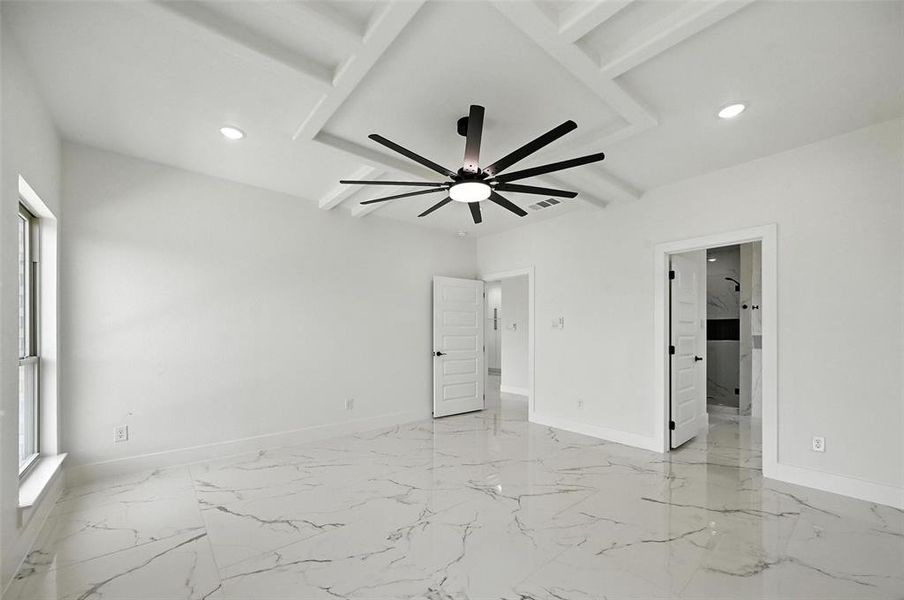 Empty room with beamed ceiling, recessed lighting, ceiling fan, and light marble finish flooring