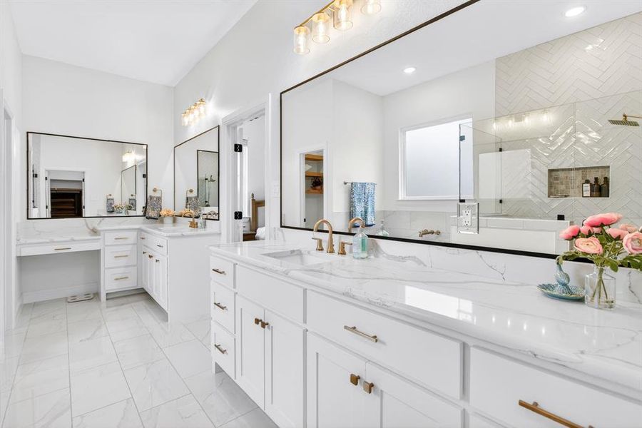 Full bathroom with two vanities, a shower stall, and light marble finish floors Full bathroom with two vanities, a shower stall, and light marble finish floors