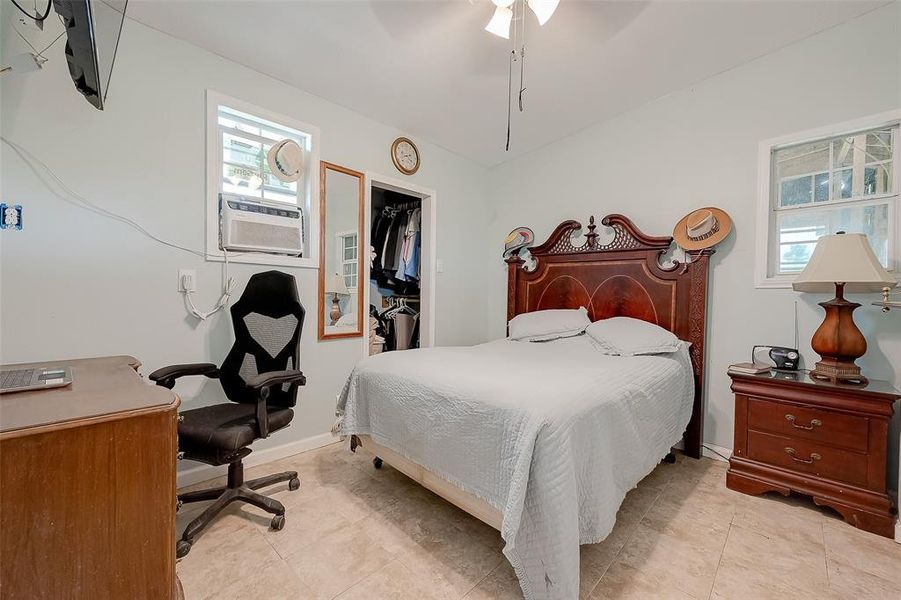 The primary bedroom boasts an inviting atmosphere with soft, muted tones.