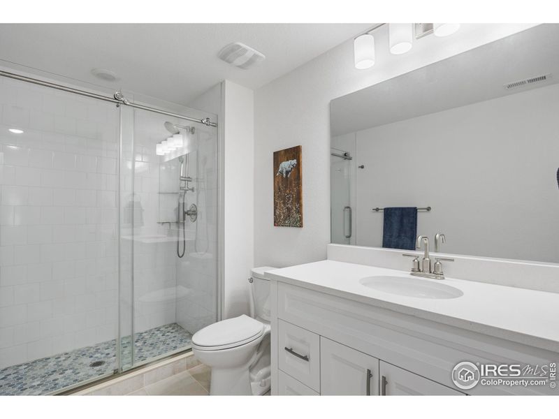 basement bathroom with custom tiled shower