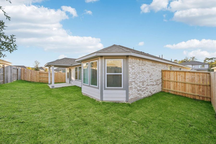 Exterior details and patio area of a home in Stewart's Ranch, Conroe (Image 24).