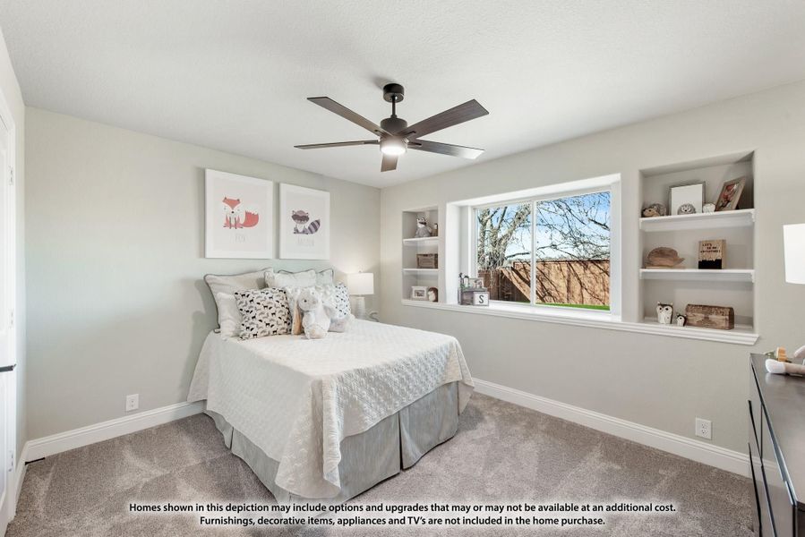 Bedroom with carpet, ceiling fan, built-in shelves flanking a window, and a full-size bed with decorative pillows