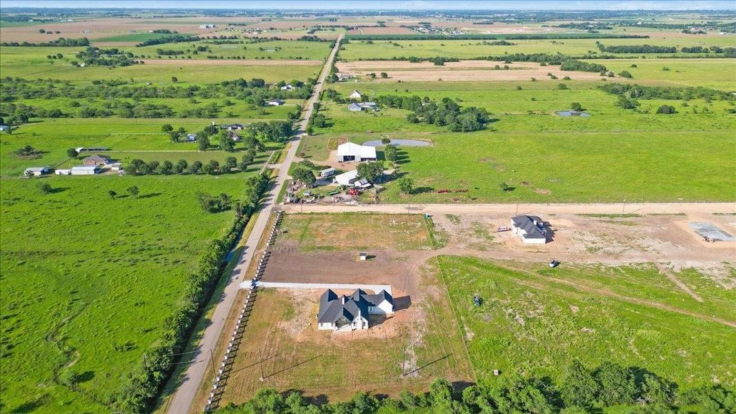Aerial perspective showcasing the peaceful rural setting and neighboring properties. Aerial perspective showcasing the peaceful rural setting and neighboring properties.