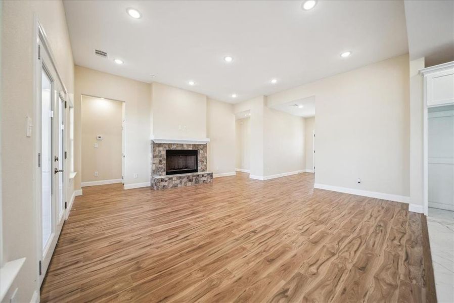 Unfurnished living room featuring a fireplace and light hardwood / wood-style floors