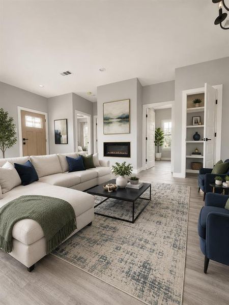 Spacious living area featuring light wood-finish flooring, and a contemporary electric fireplace