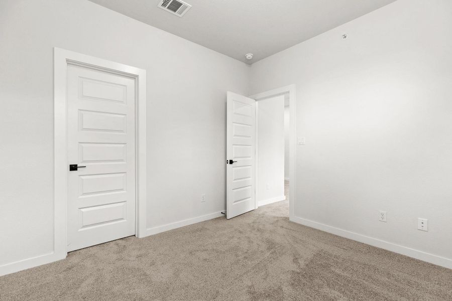A well-lit, neutral-toned room provides a versatile canvas for personalized decor and comfort. A well-lit, neutral-toned room provides a versatile canvas for personalized decor and comfort.