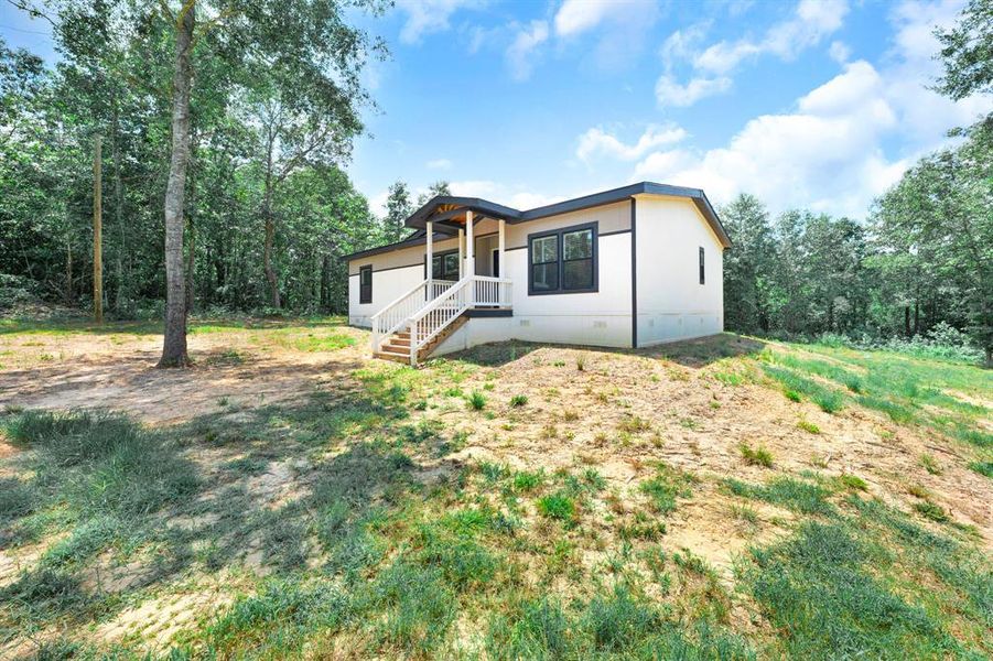 Front exterior of a new home in , Gilmer, TX, highlighting curb appeal (Image 20). Front exterior of a new home in , Gilmer, TX, highlighting curb appeal (Image 20).