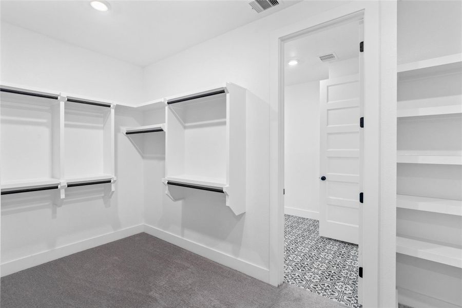 Look at this immaculate closet! With high shelving, multiple rows to hang clothing, you are sure to have enough room for all your belongings! Added feature is the convenient door that leads directly into the laundry room.