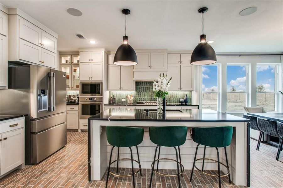 The oversized kitchen island is the hub of this fantastic home!