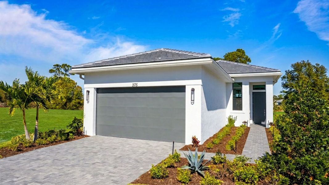 Front exterior of a new home in Rivella, Port St. Lucie, FL, highlighting curb appeal (Image 1). Front exterior of a new home in Rivella, Port St. Lucie, FL, highlighting curb appeal (Image 1).
