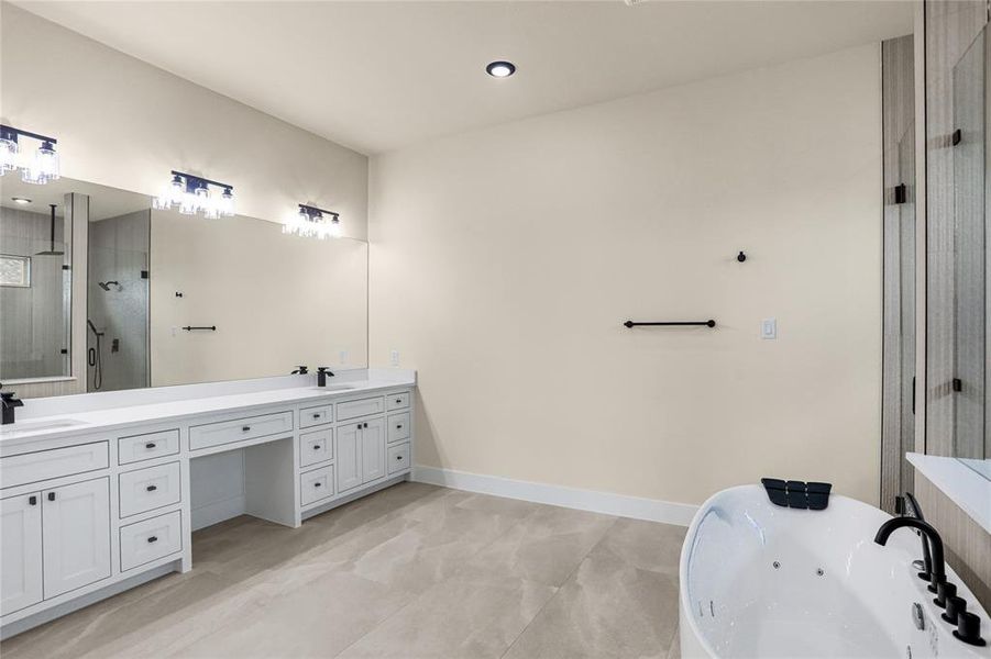 Full bath with double vanity, a jetted tub, and a stall shower Full bath with double vanity, a jetted tub, and a stall shower