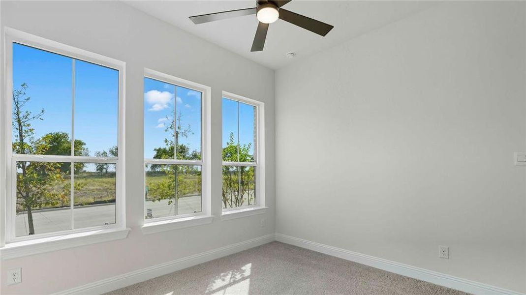 Unfurnished room featuring ceiling fan and light carpet