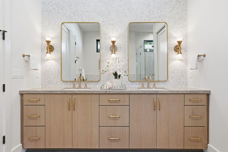 Full bath with double vanity and baseboards