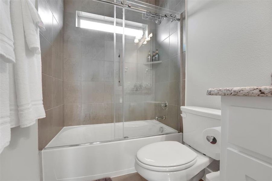 Full bathroom with vanity and shower / bath combination with glass door