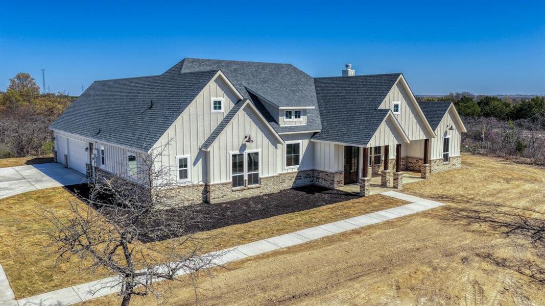Front exterior of a new home in Echo Grove, Poolville, TX, highlighting curb appeal (Image 26).