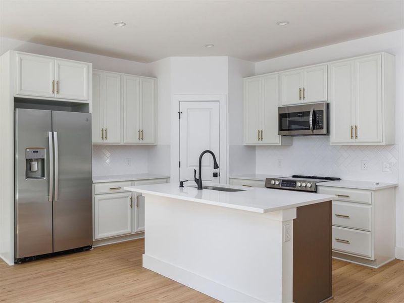 Kitchen is open to living.View out to back via large windows.