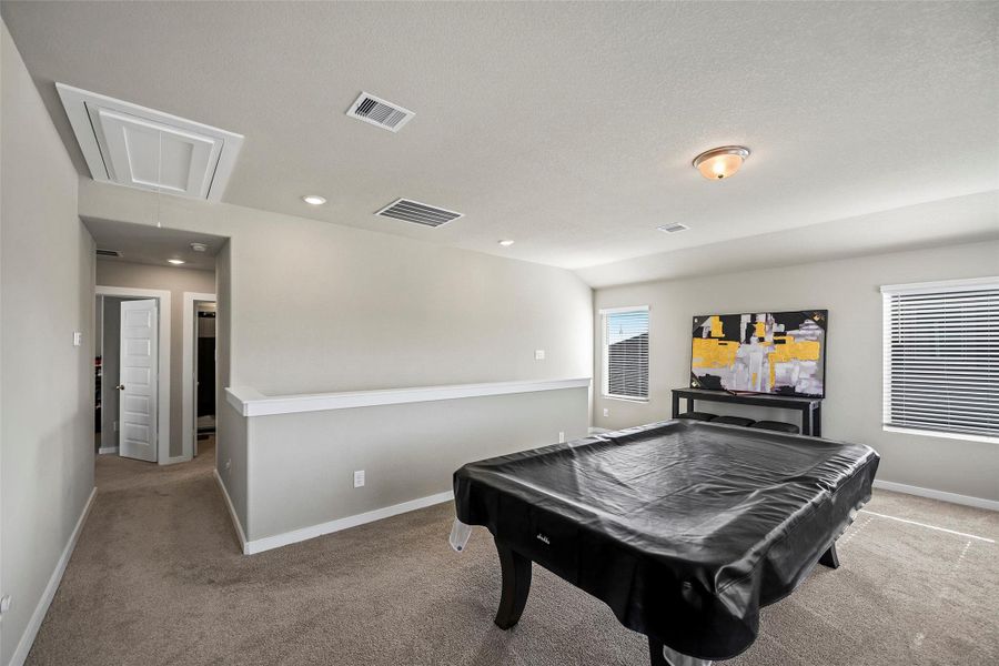 Another view of the game room leading to the 3 bedrooms.