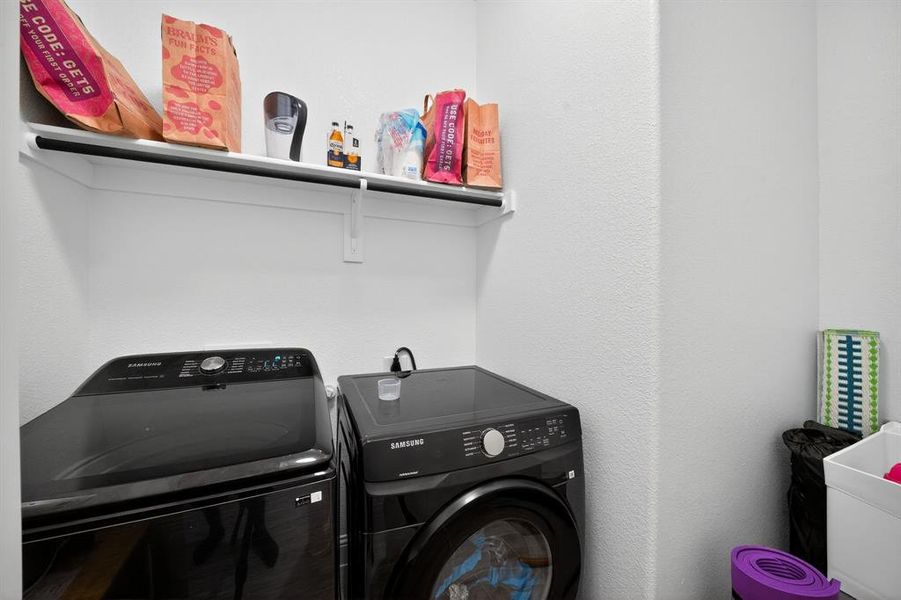 Laundry area featuring washing machine and clothes dryer
