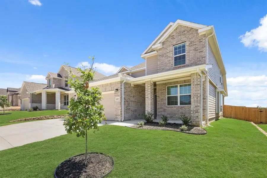 Front exterior of a new home in Rocky Creek Crossing, Fort Worth, TX, highlighting curb appeal (Image 12). Front exterior of a new home in Rocky Creek Crossing, Fort Worth, TX, highlighting curb appeal (Image 12).