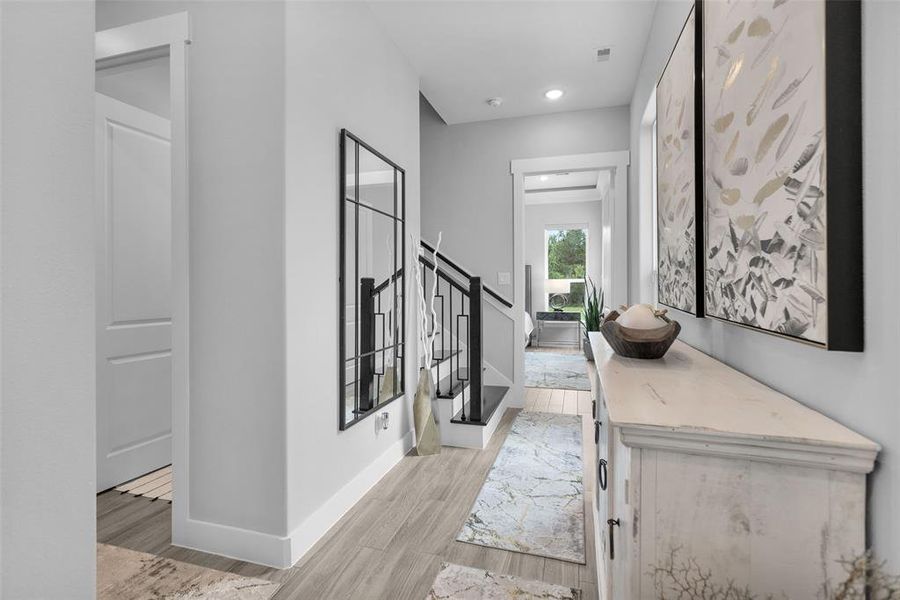 Hallway from the kitchen leads to primary, mud room, stairway, utility and half bath.