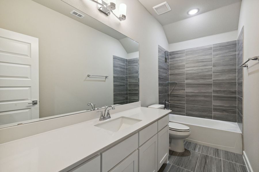 Bathroom in the Morrison home plan by Trophy Signature Homes – REPRESENTATIVE PHOTO