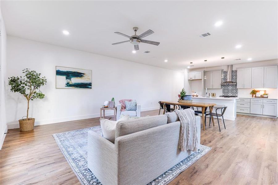 Living room featuring ceiling fan and light wood-type flooring