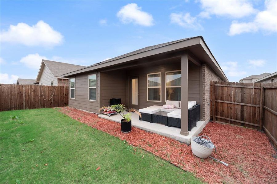 Rear view of house featuring an outdoor hangout area, a fenced backyard, and a patio