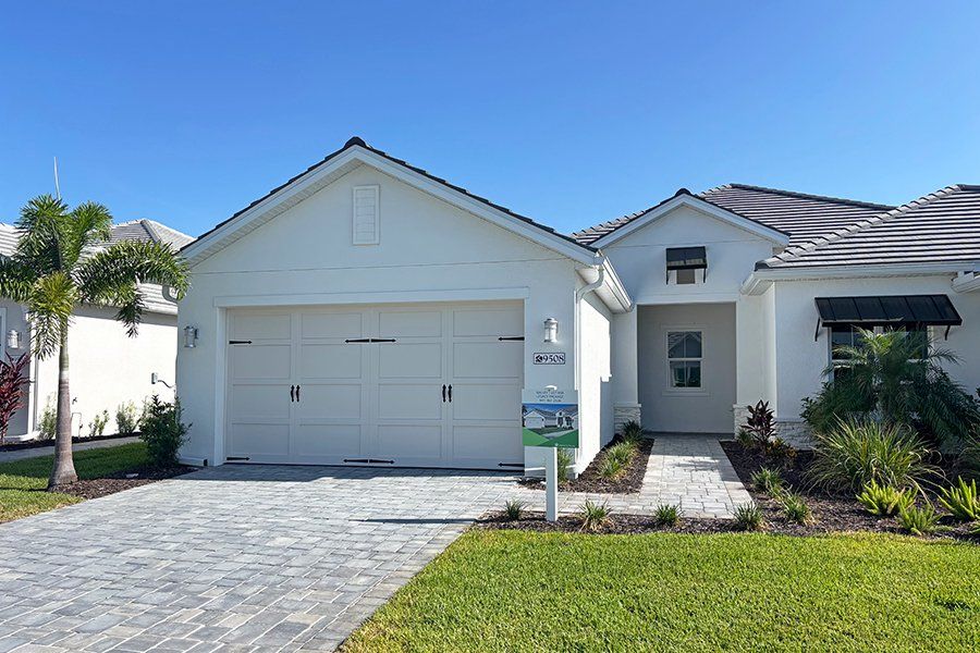 Front exterior of a new home in Shellstone at Waterside, Sarasota, FL, highlighting curb appeal (Image 1). Front exterior of a new home in Shellstone at Waterside, Sarasota, FL, highlighting curb appeal (Image 1).