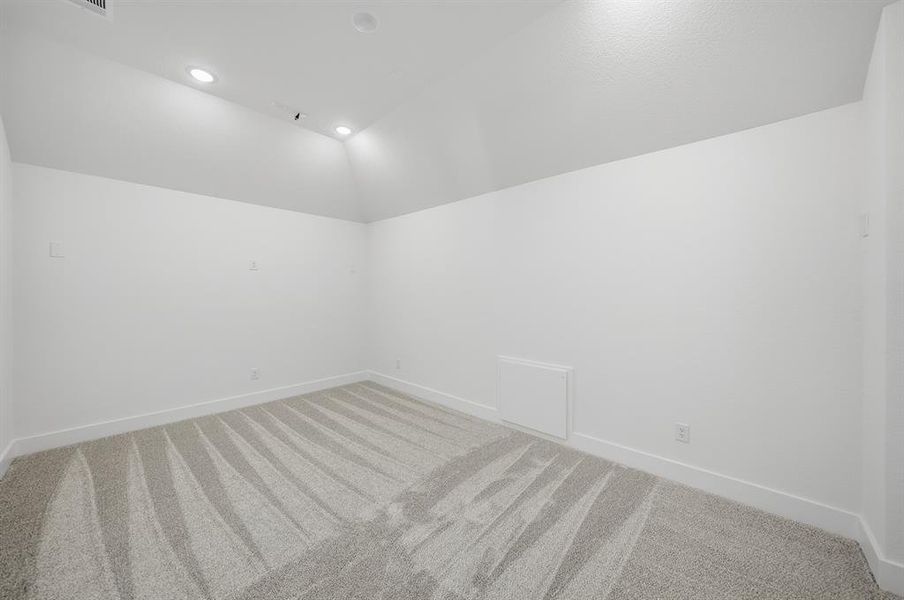 Bonus room with lofted ceiling, carpet floors, and recessed lighting Bonus room with lofted ceiling, carpet floors, and recessed lighting