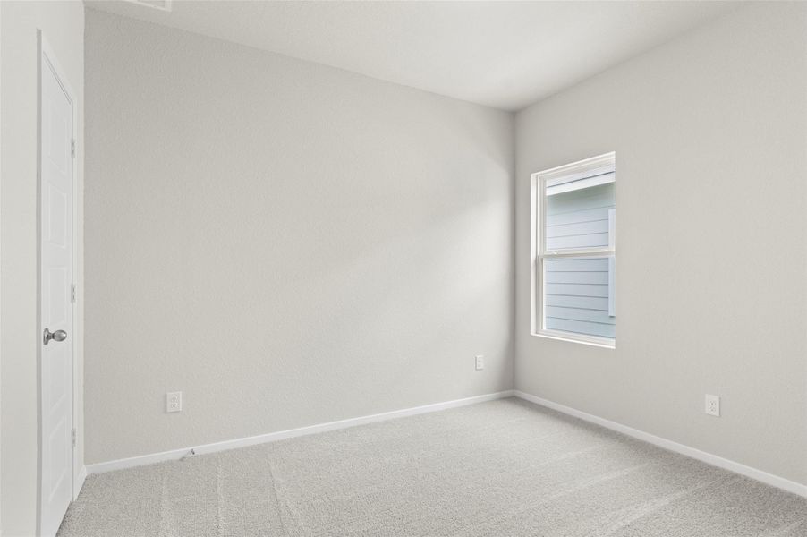 Empty room with light colored carpet and baseboards Empty room with light colored carpet and baseboards