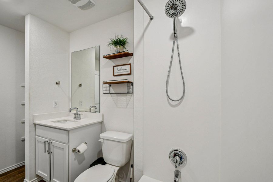 Bathroom featuring vanity and washtub / shower combination