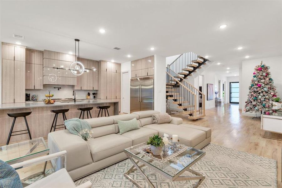 Living room featuring sink and light hardwood / wood-style floors