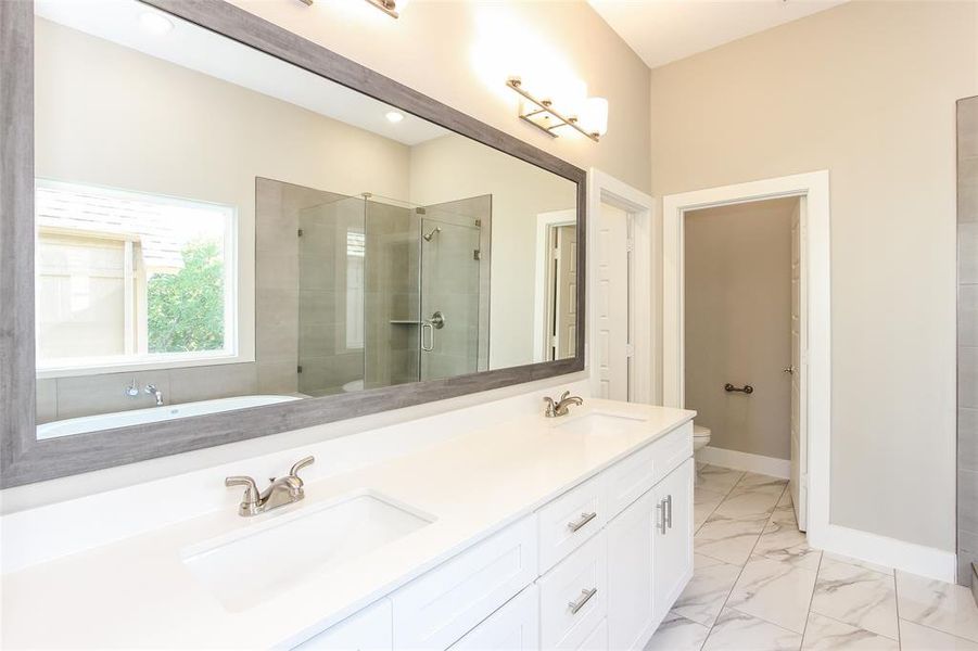 Bathroom with vanity, toilet, and an enclosed shower