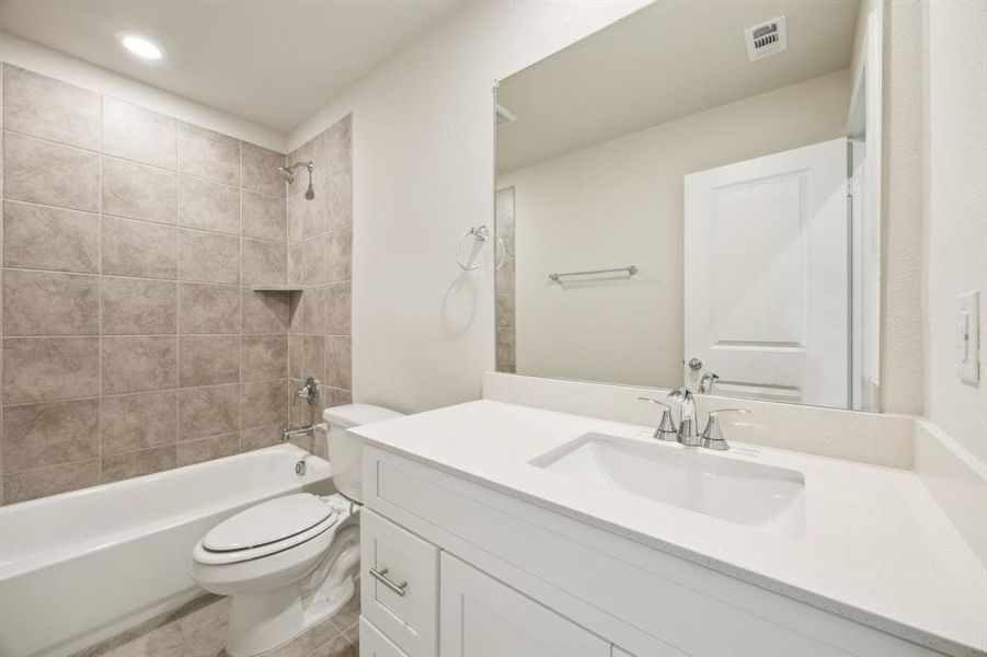 Full bathroom with toilet, shower / bath combination, vanity,  and tile patterned floors