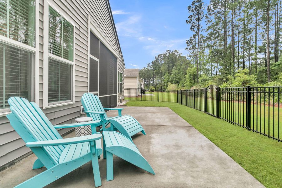 Exterior details and patio area of a home in K. Hovnanian's® Four Seasons at Lakes of Cane Bay, Summerville (Image 24).